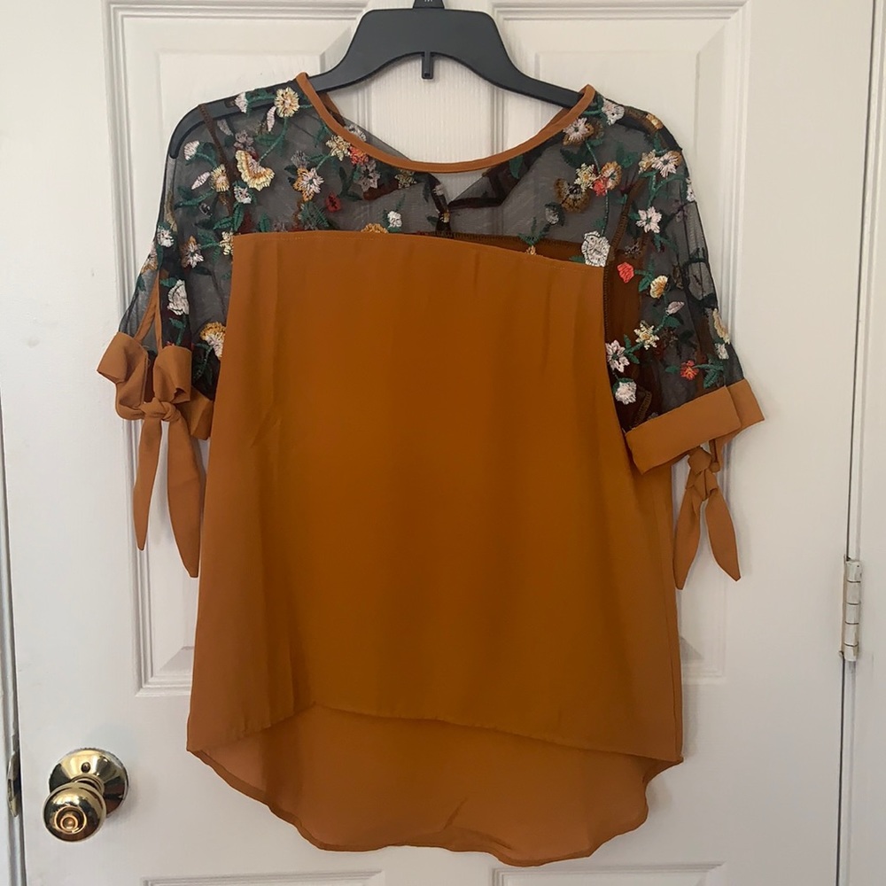 Tan shirt with sheer floral shoulder design!